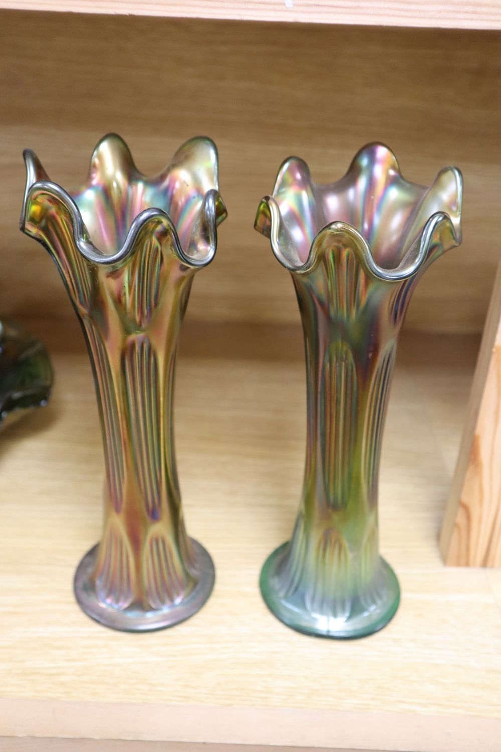 A quantity of mixed green and orange Carnival glass dishes and vases